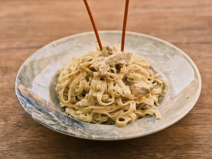 Healthy Chicken Alfredo with chicken breast, fettuccine, and broccoli florets in a creamy parmesan sauce